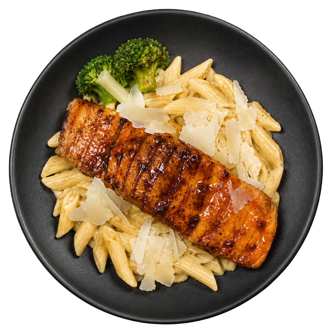 Grilled salmon over creamy pasta with broccoli and parmesan